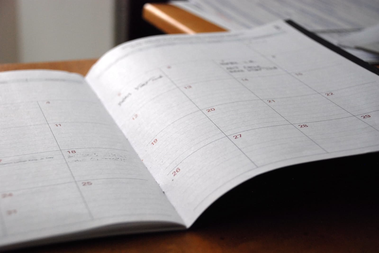 Open monthly planner on wooden desk